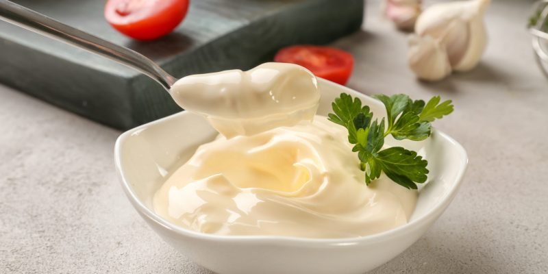 Delicious,Mayonnaise,In,Bowl,And,Spoon,On,Kitchen,Table,,Closeup